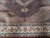 Detail of the ivory palmette main border, guard stripes and burgundy field edge
