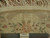 Back of the 8 foot round rug beside a ruler proving fine hand-knotted wool weave