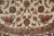 Symmetrical floral cluster where the ivory field meets the sage green floral guard border