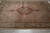 Overhead view of the 7x10 wool and silk rug showing scalloped medallion and sage main border