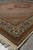 Low angle of the corner fringe, layered guard borders and sage floral surround on tile