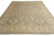 Hand-knotted wool Ziegler rug shown at an angle, gray field framed by golden beige borders