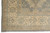 Gray field meeting the beige main border, drawn with scrolling vines and octagonal medallions