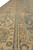 Guard borders in gold and teal running beside the slate gray field of this rug