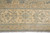 Main border close-up with symmetrical palmettes, curling leaves and pale fringe along the finished end