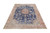 Angled display of the 9'4" x 12' Persian Kerman rug showing denim blue medallion field