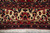 Ivory main border close-up with pink palmettes, navy leaves and two red rosette guard stripes