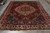 9' x 11'7" Persian Bakhtiar rug photographed lengthwise, ivory medallion floating above deep wine red ground
