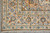 10x14 Kashan rug corner showing triple border, blue palmette vine scroll and ivory fringe