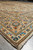 Angled corner photograph of ivory and peach Kashan rug with neat selvedge and clean fringe
