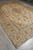 Full angled view of 9'8" x 13'9" Kashan rug displayed on grey tile floor