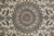 Macro detail of wool and silk pile showing the 16 petal rosette and navy outlines