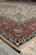 Perspective shot of the 6'6" x 10' Tabriz design rug corner and flowing arabesque field