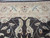 Border detail of palmettes, guard stripes and leaf sprays meeting the dark brown floral field