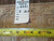 Reverse of the rug with hand woven Oriental rug tag number 6271 and tape measure across knot rows