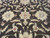 Field close-up showing two ivory rosettes, terracotta accents and hand-spun wool striations in the brown background