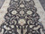 Large 8 by 11 rug viewed lengthwise, all-over floral drawing mirrored across the vertical axis