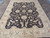Neutral brown and sand rug staged on tiled flooring, a practical size for living room seating