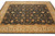 Gold main border with sage green leaves framing the black field of this large wool rug