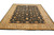 Angled view of hand-knotted wool rug showing golden palmettes scattered across a deep black ground