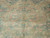 Macro view of medallion rosette showing dense wool knots, salmon outlines and soft gray green shading