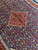 10x13 Persian Mahal rug close-up of red diamond medallion on navy Herati fish pattern