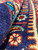 Rolled edge showing thick wool pile depth with orange and turquoise border detail on navy