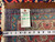Back of rug with tape measure and tag reading rug number 6932, size 9.8 x 13.5