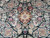 Symmetrical floral repeat in cream, tan and wine red set on a deep black ground