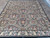 8'1 x 10'3 Oriental rug seen wide, showing floral borders and black all-over field