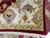 Folded corner revealing ivory main border, sage minor border and ivory cotton fringe ends