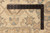 Ruler on ivory border measuring pile and knot density of this Pakistani hand-knotted wool rug