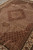 8 x 11 rug angled to show silk sheen across the beige Herati lattice