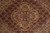 Macro of the central medallion with olive, rust, navy and cream floral drawing