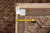 Back of rug with tape measure and dealer tag confirming the 8'3 x 11 size