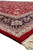 Corner view showing navy main border, red selvage, powder blue guard stripe and ivory fringe