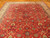 10'2" x 13'2" Persian Tabriz rug displayed on parquet wood floor showing red floral field
