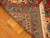 Back of 10x13 Tabriz rug folded to reveal fine knotting and cotton foundation weave