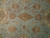 Detail of teal field with gold cartouche medallion, palmettes, leafy vines and small rust floral sprays