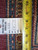 Back of the rug with inventory tag reading 6166 and tape measure showing weave