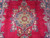 Close view of the 8 petal star medallion woven in cream, navy and rose