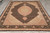 Angled view of 8x10 wool and silk area rug showing ivory fringe and black outer border