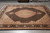 7'9" x 9'9" Oriental rug photographed flat on grey tile, black field and floral border
