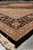 Low angle down the length of this black and beige Oriental area rug, borders sharp