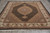 Angled floor view showing scalloped medallion, lattice field, wide ivory border and ivory cotton fringe