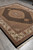 Hand-knotted 8x10 area rug shot from the corner showing ivory border and black outer edge