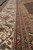 Border close-up with ivory vine scroll, rust guard stripes and olive green minor bands