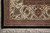 Corner detail of the ivory main border with palmettes, blossoms and black outer guard band