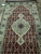 End section of the Indian Mahi runner on tile, medallion, pendants and ivory border fully visible