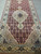 Pom red field with dense diamond lattice, ivory medallion and pendant on this 21 foot runner